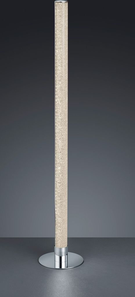 A tall, cylindrical floor lamp with a clear, textured tube and a silver base, set against a plain gray background.