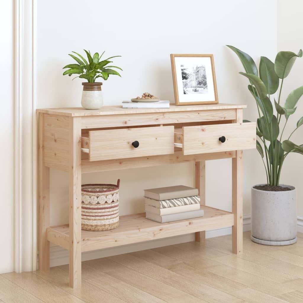 A wooden console table with two drawers and a lower shelf, decorated with plants and books.