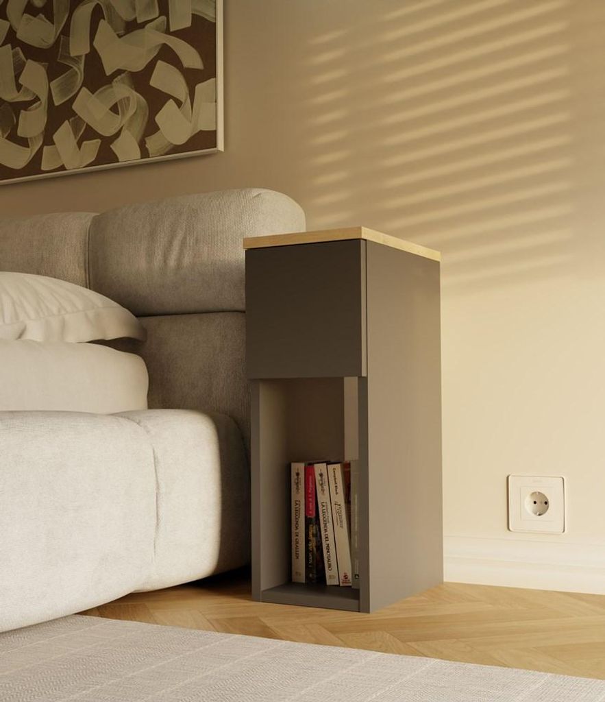 A bedside table next to a bed, with books on the shelf and a painting on the wall.