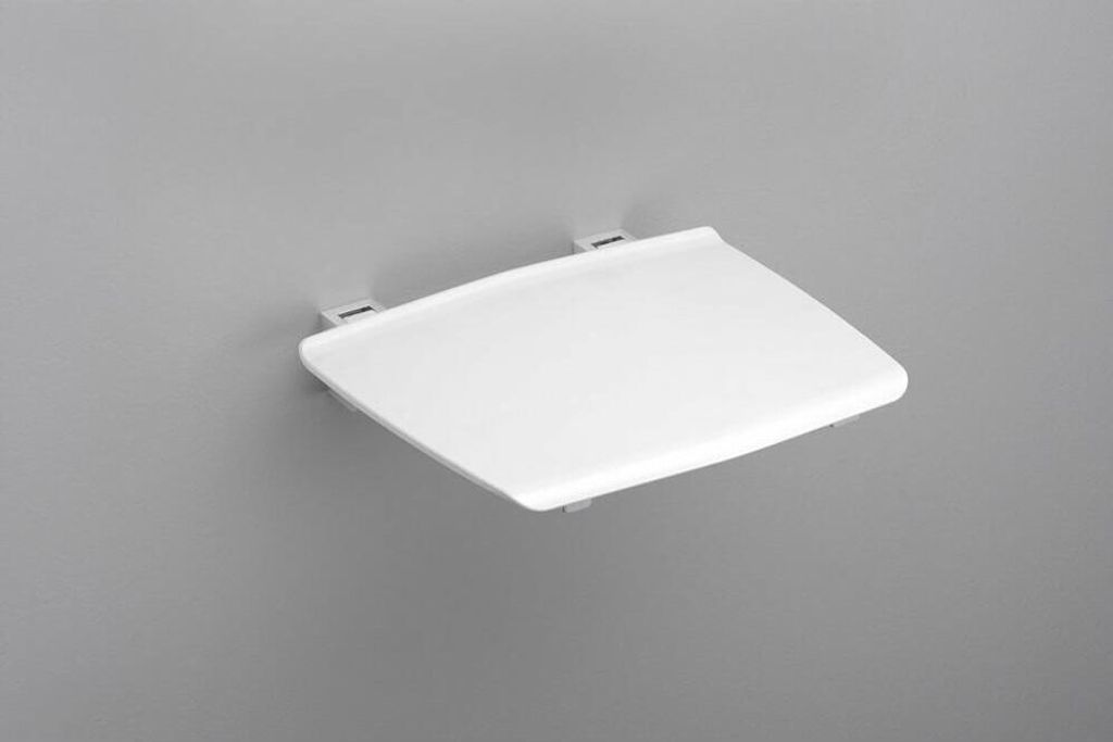 A white shower seat is mounted on a gray wall.