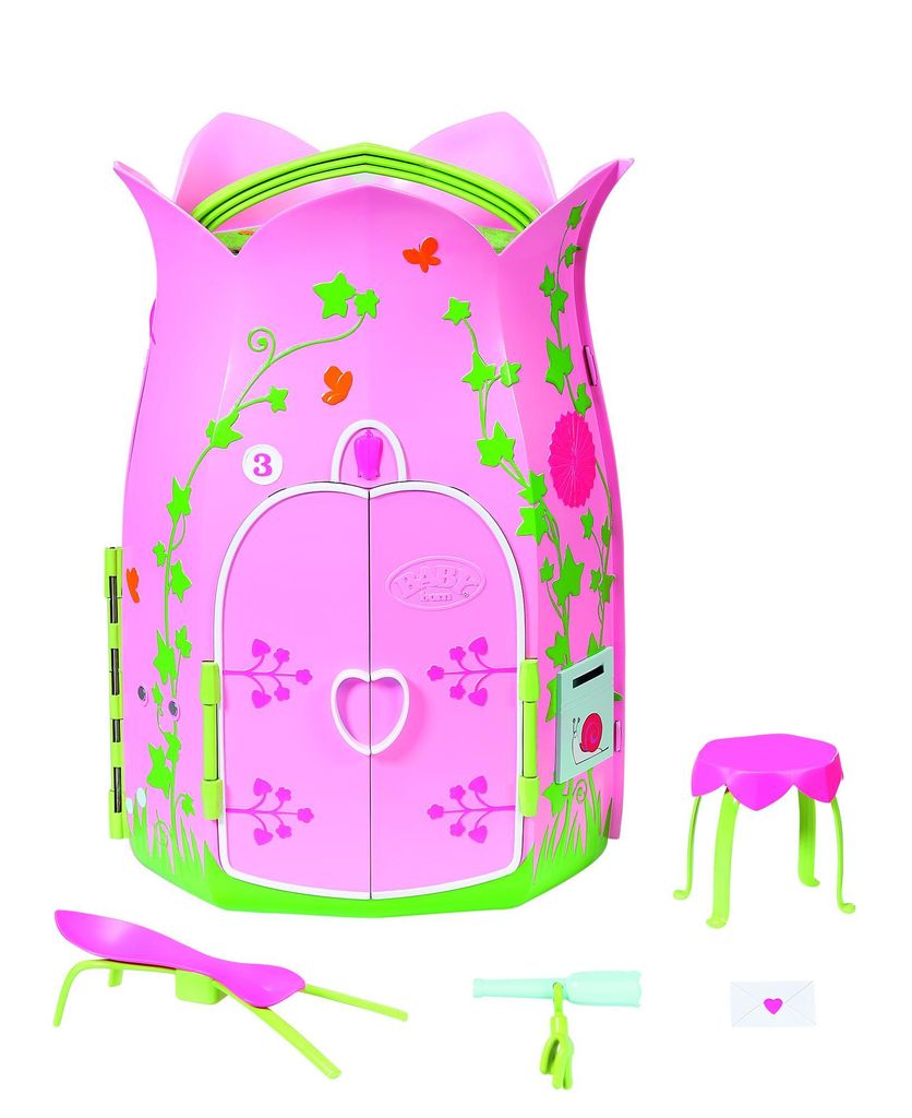 A pink toy cottage with green vine decorations and accessories.