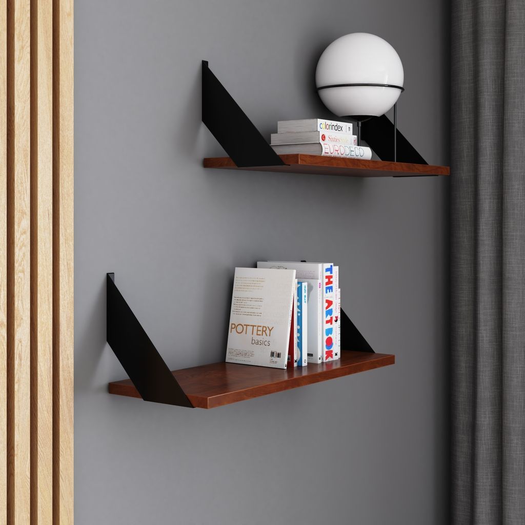 Two modern shelves mounted on a gray wall, displaying books and a lamp.