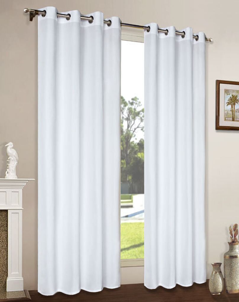A pair of white curtains hanging in front of a window, with a fireplace and a decorative statue on the left, and a framed picture and vases on the right.