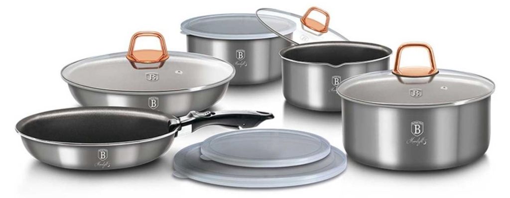 A collection of stainless steel cookware with copper-colored handles and glass lids, arranged on a white background.
