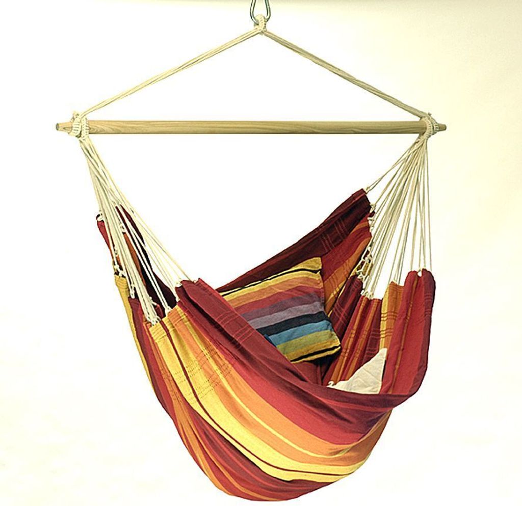 A colorful striped hammock chair hanging from a wooden spreader bar.