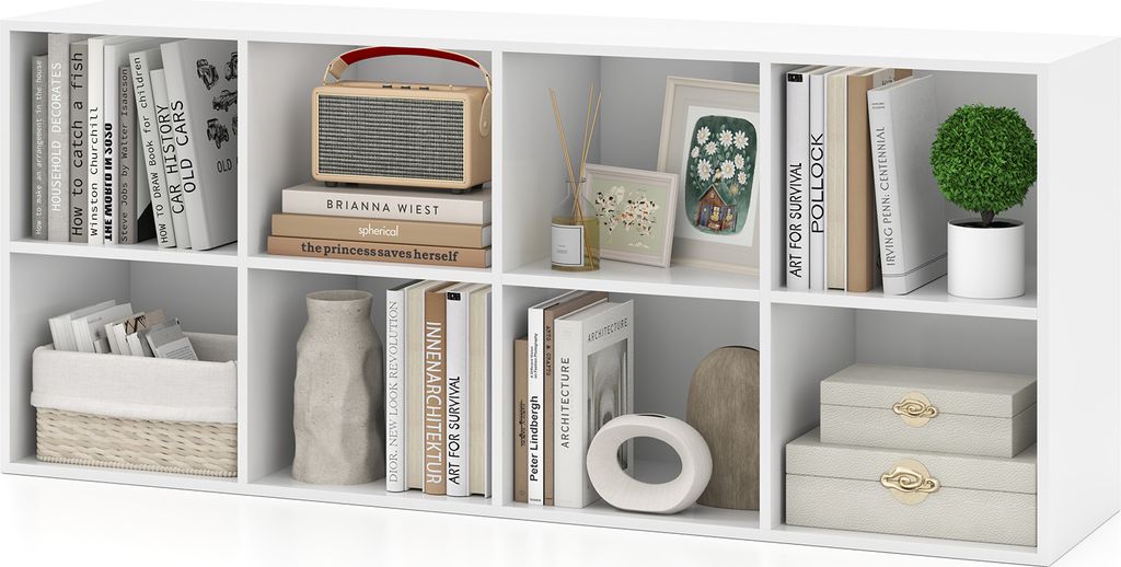 A white cube storage unit filled with books, decorative items, and storage baskets.