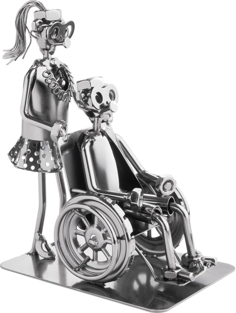 A metal sculpture of a nurse pushing a person in a wheelchair.