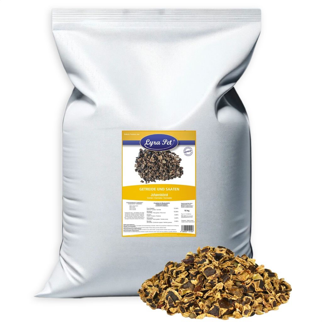 A large white bag of pet food with a label and a pile of the food in front of it.