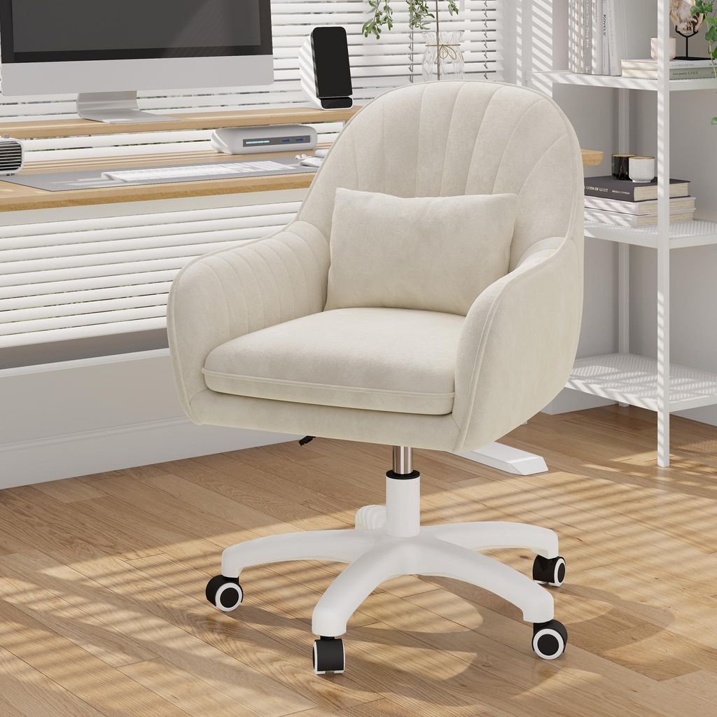 A beige velvet office chair with a small pillow is shown in a home office setting.