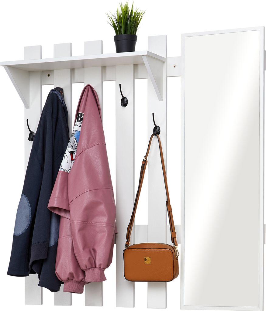 A white coat rack with a shelf, hooks, and a mirror, holding two jackets and a handbag.