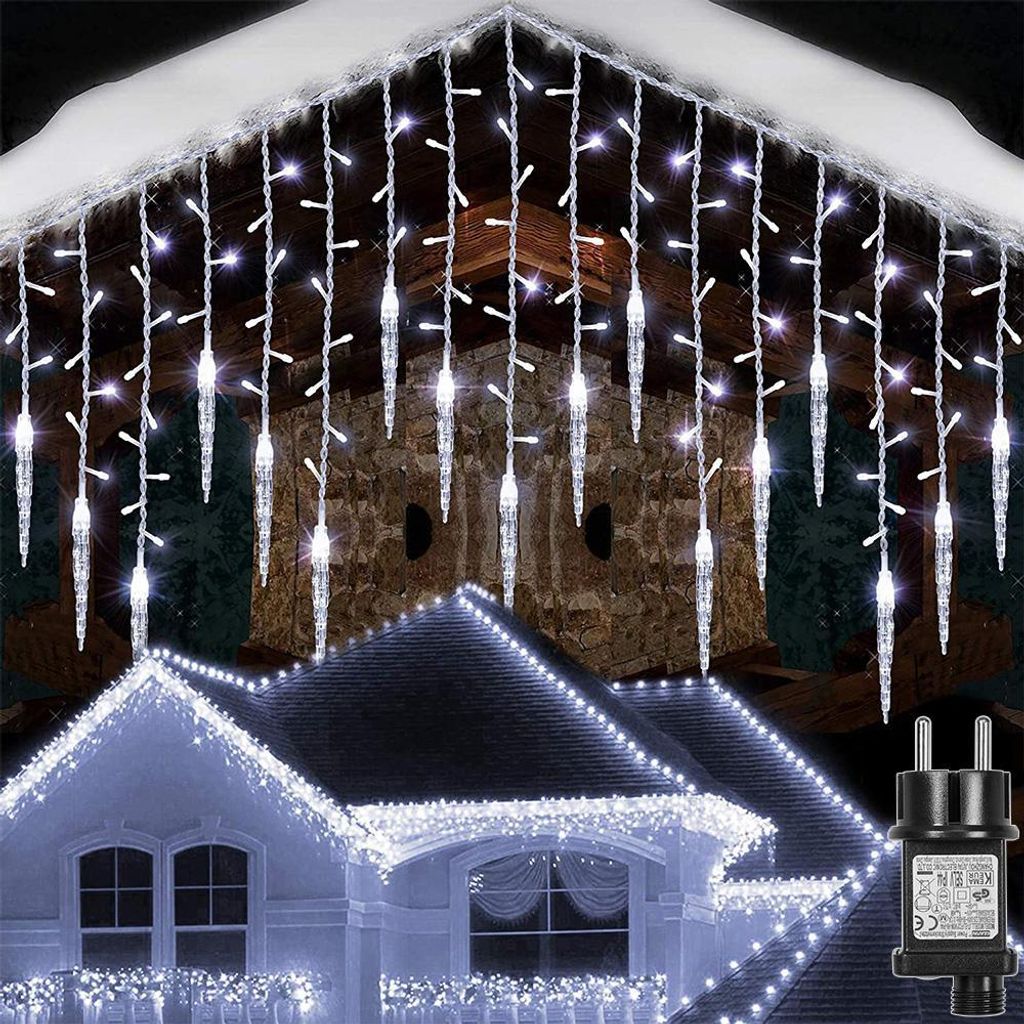 Icicle lights are decorating the roofline of a house at night.