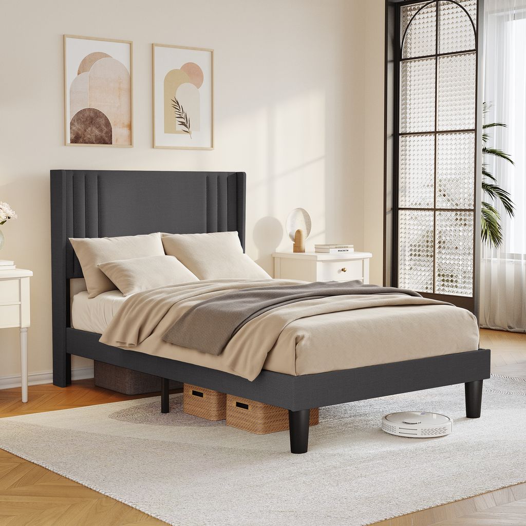 A bedroom scene with a bed, nightstand, and artwork.