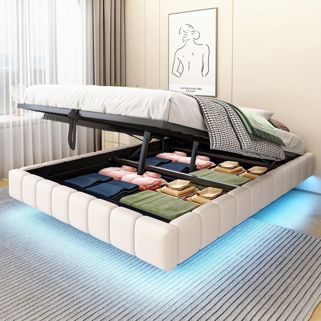 A bed with its storage compartment open, revealing neatly folded linens and towels. The bed has LED lighting underneath.