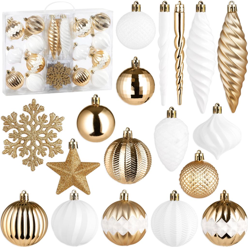 A collection of gold and white Christmas ornaments, including baubles, snowflakes, icicles, and pinecones, arranged on a white background.