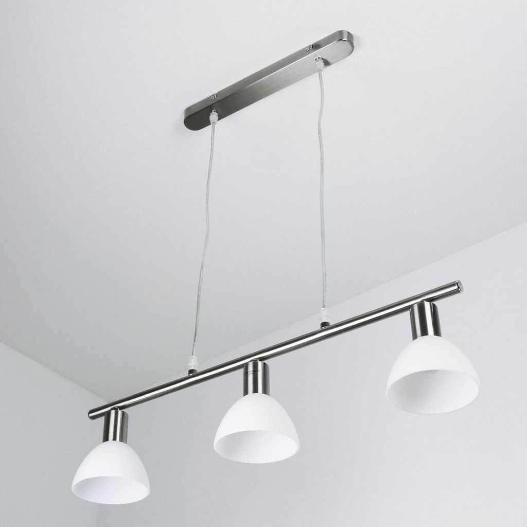 A modern pendant light fixture with three white glass shades hanging from a silver bar, suspended from a white ceiling.