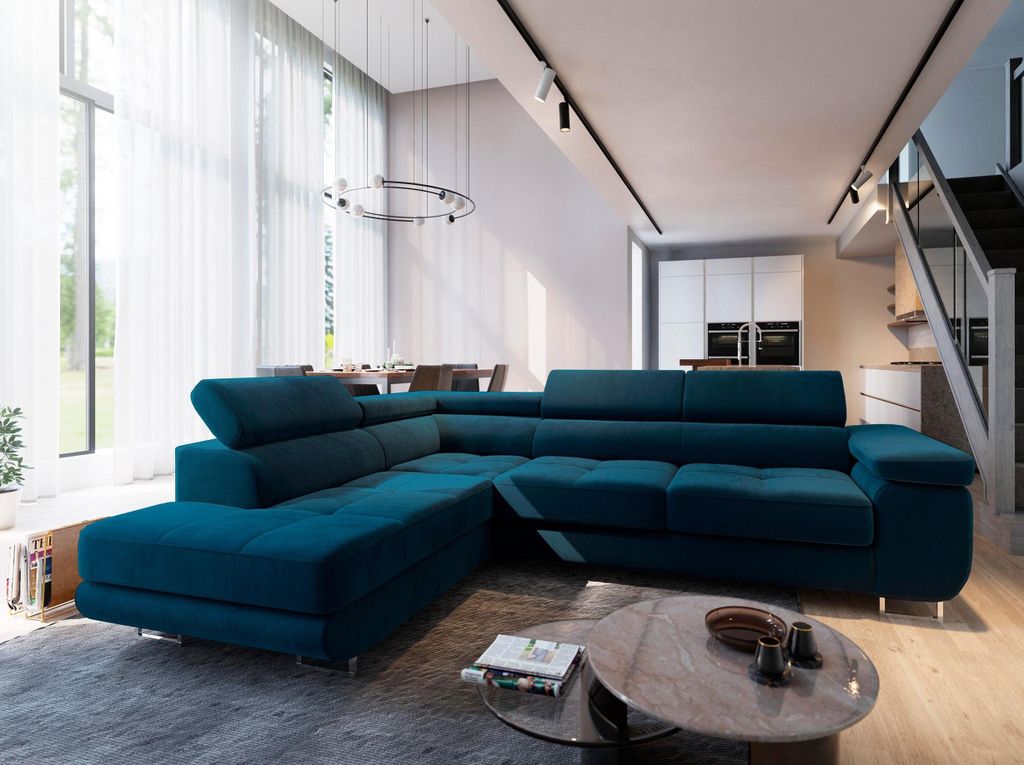 A modern living room with a large sectional sofa, dining area, and kitchen in the background.
