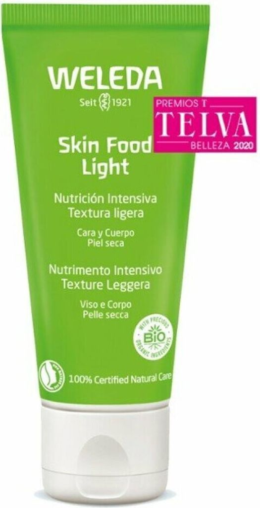 A green tube of Weleda Skin Food Light cream with a white cap, set against a white background. There is a pink award sticker on the upper right side of the tube.