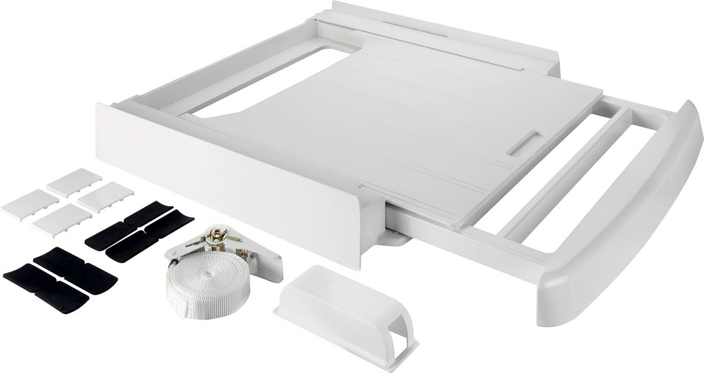 A white washing machine and dryer accessory kit is laid out on a white background.
