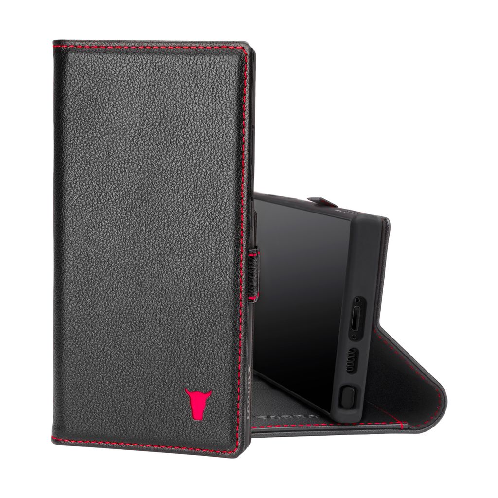 A black leather phone case with red stitching and a red bull logo is shown open, with a phone inside.