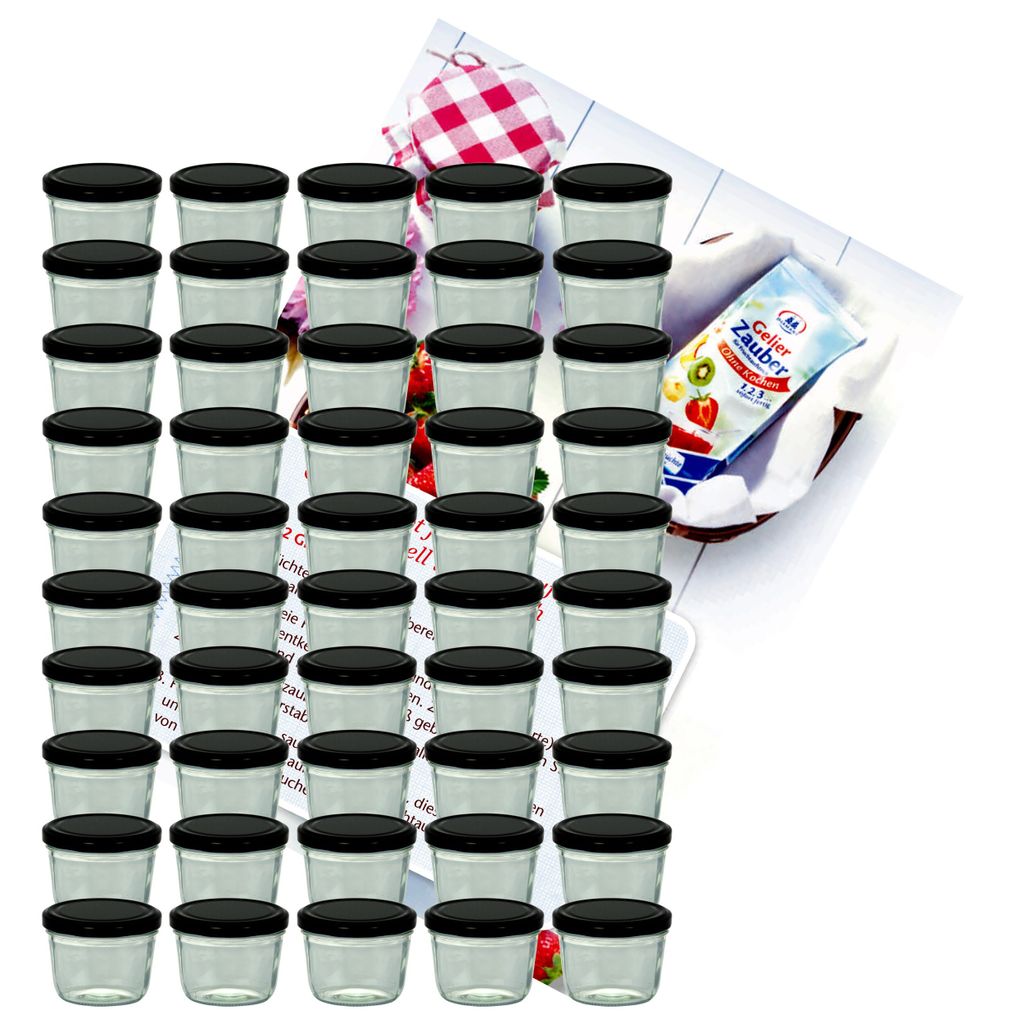 A collection of small glass jars with black lids, arranged in rows, with a small packet of what appears to be dessert mix in the background.