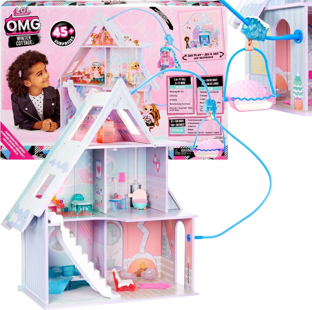 A child looking at the L.O.L. Surprise! OMG Winter Cottage dollhouse packaging, with the dollhouse itself prominently displayed.