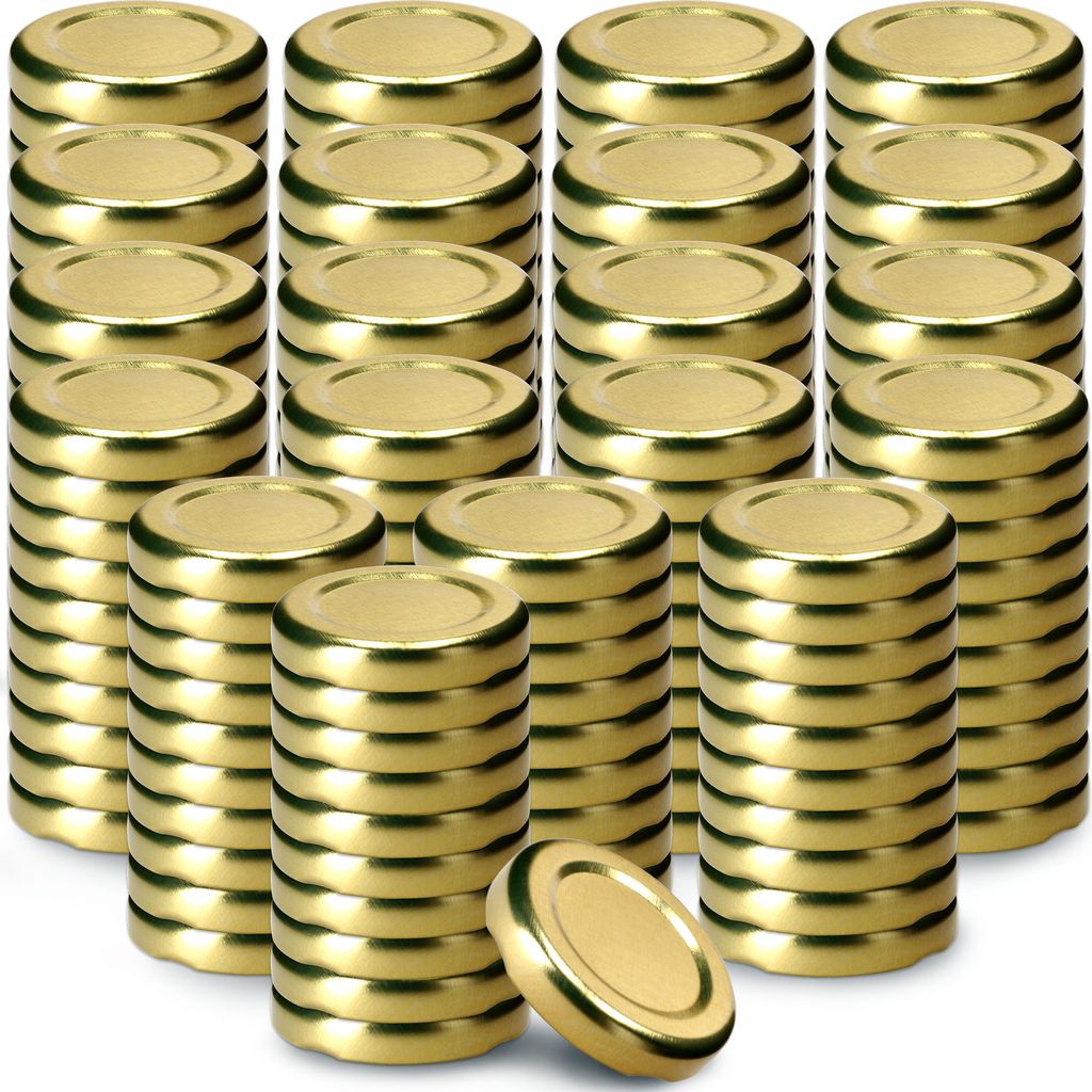 A collection of gold metal jar lids stacked in columns.