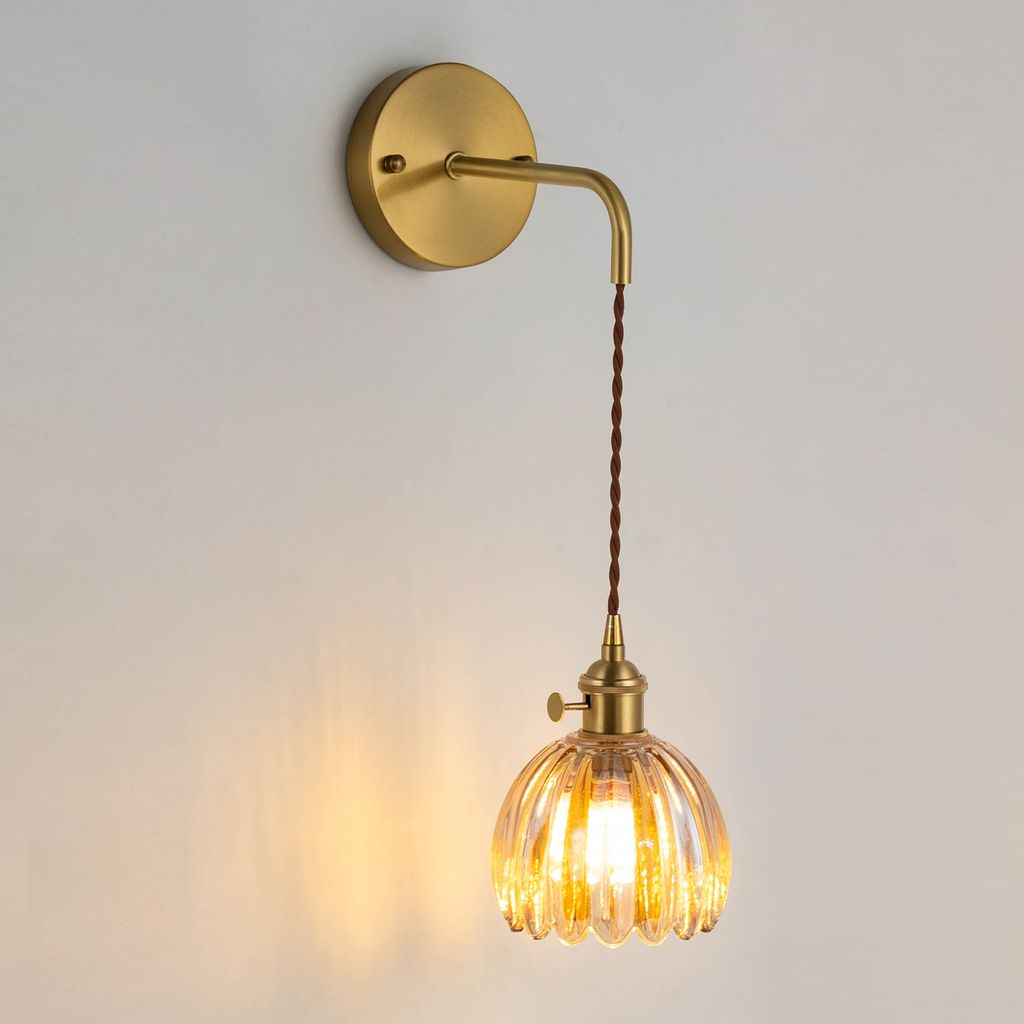 A vintage-style wall lamp with a glass shade.