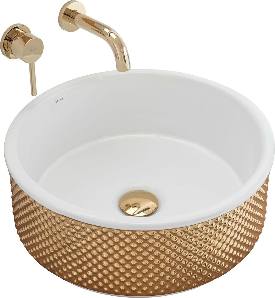 A gold and white washbasin with a gold faucet.