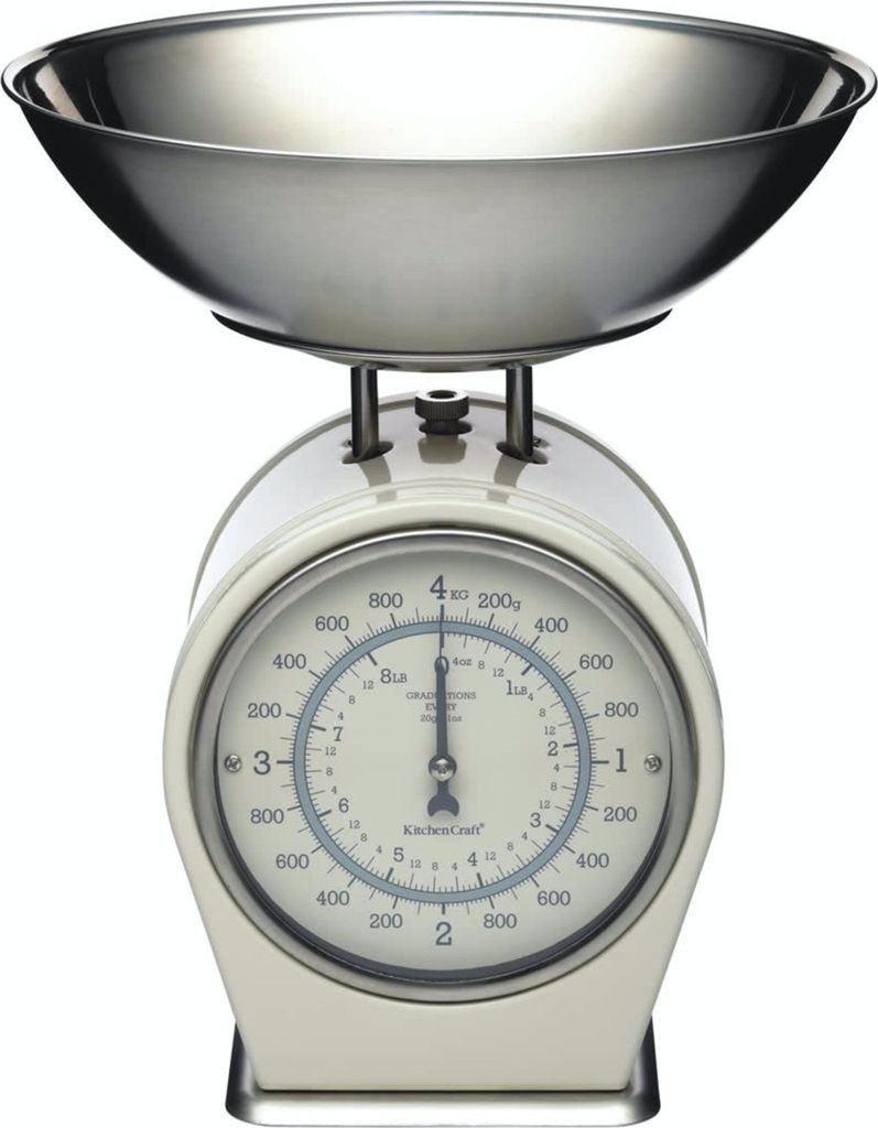 A cream-colored mechanical kitchen scale with a silver bowl on top, set against a white background.