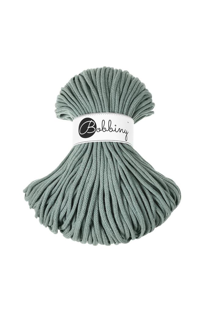 A spool of green cord with a white label.