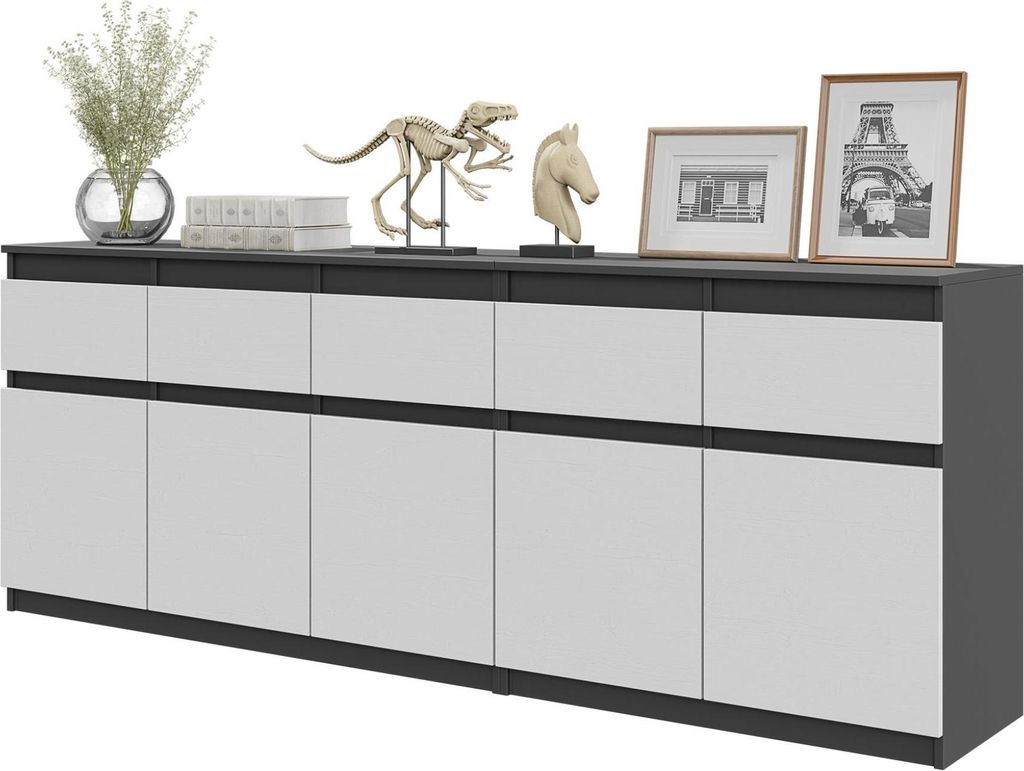 A modern sideboard with a dark top and white doors, decorated with various objects.