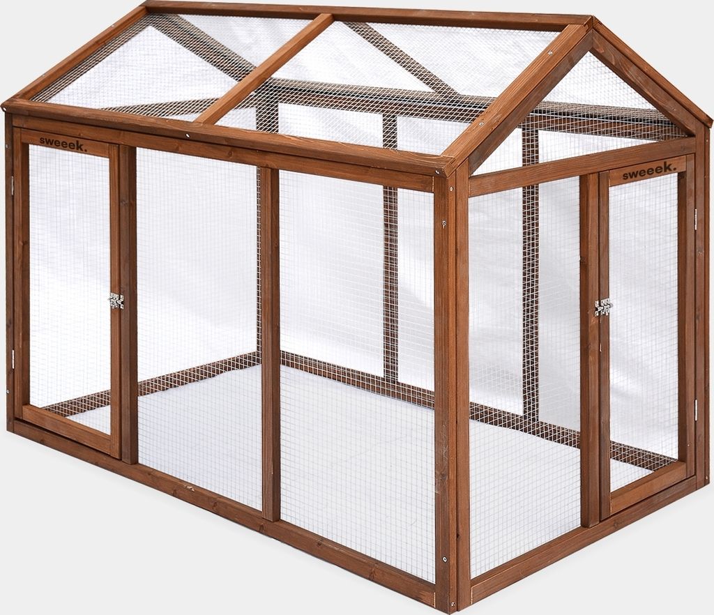 A wooden chicken coop with mesh panels and a pitched roof.