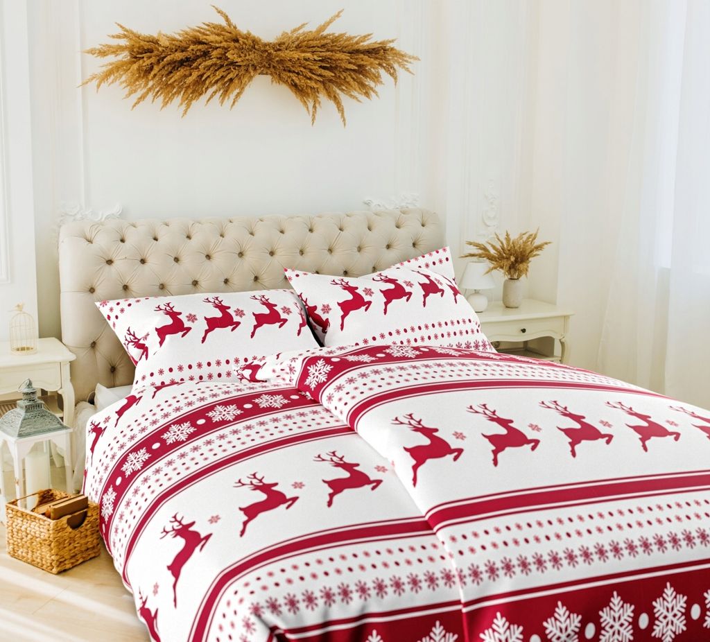 A Christmas-themed duvet cover and pillowcases with a reindeer pattern are displayed on a bed.