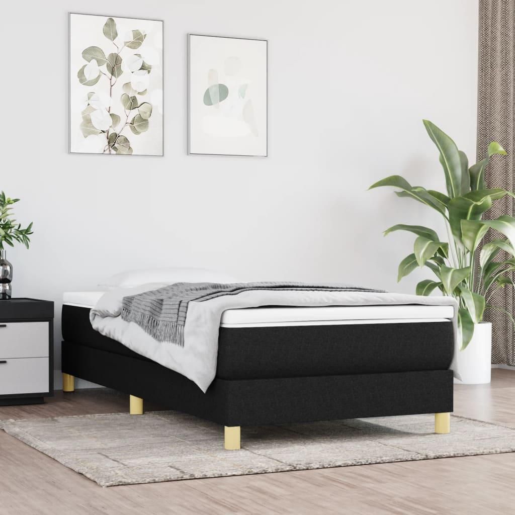 A bedroom scene with a bed, nightstand, and plant.