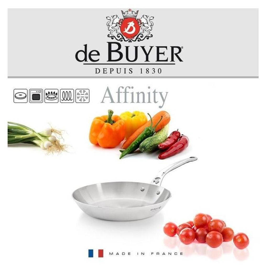 A De Buyer Affinity frying pan with various vegetables and cherry tomatoes.