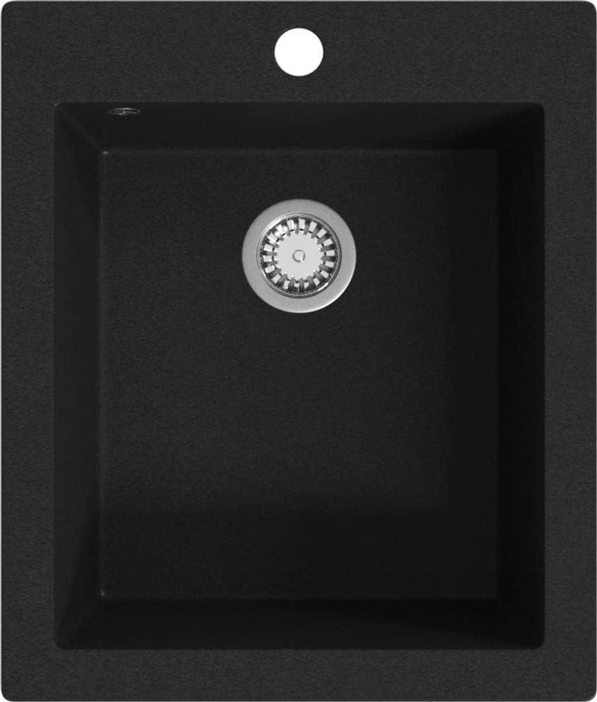 A top-down view of a black granite kitchen sink with a silver drain.