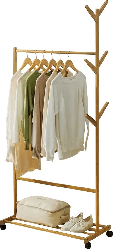 A wooden garment rack with clothes hanging on it, a storage bag, and shoes on the bottom shelf.