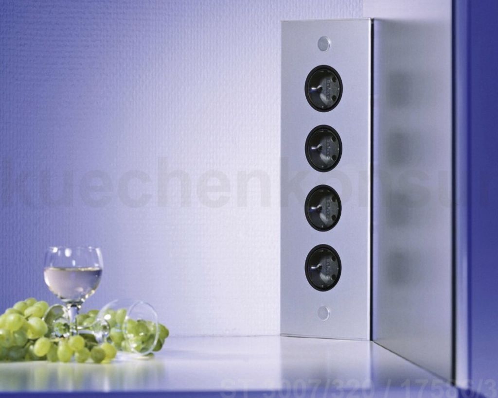 A wine glass and grapes are in the foreground, with a vertical electronic column in the background.