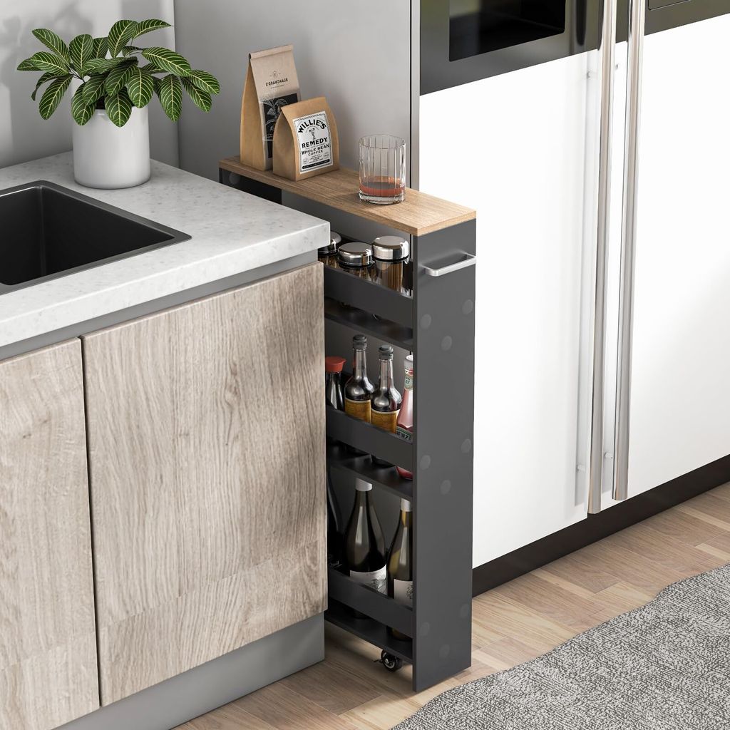 A narrow, multi-tiered rolling cart filled with bottles and jars, positioned between a kitchen counter and a refrigerator.