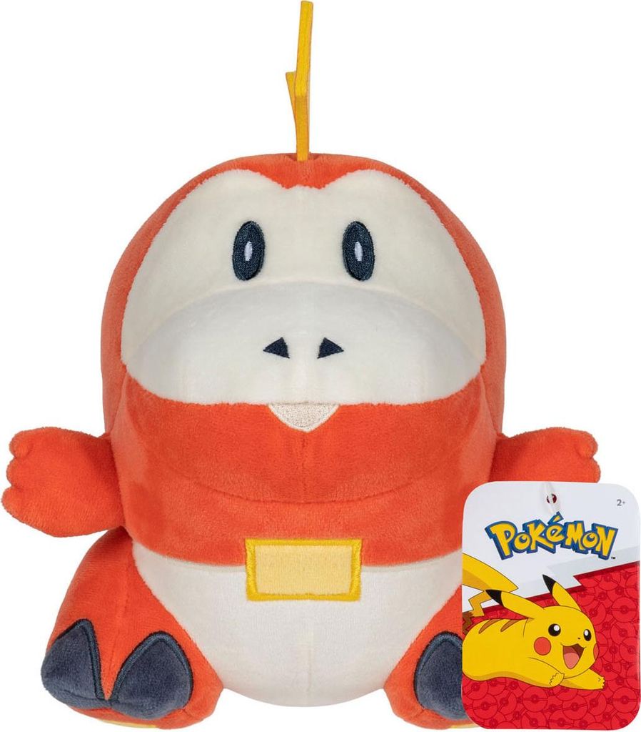 A plush toy of the Pokemon character Fuecoco, with its official tag attached.