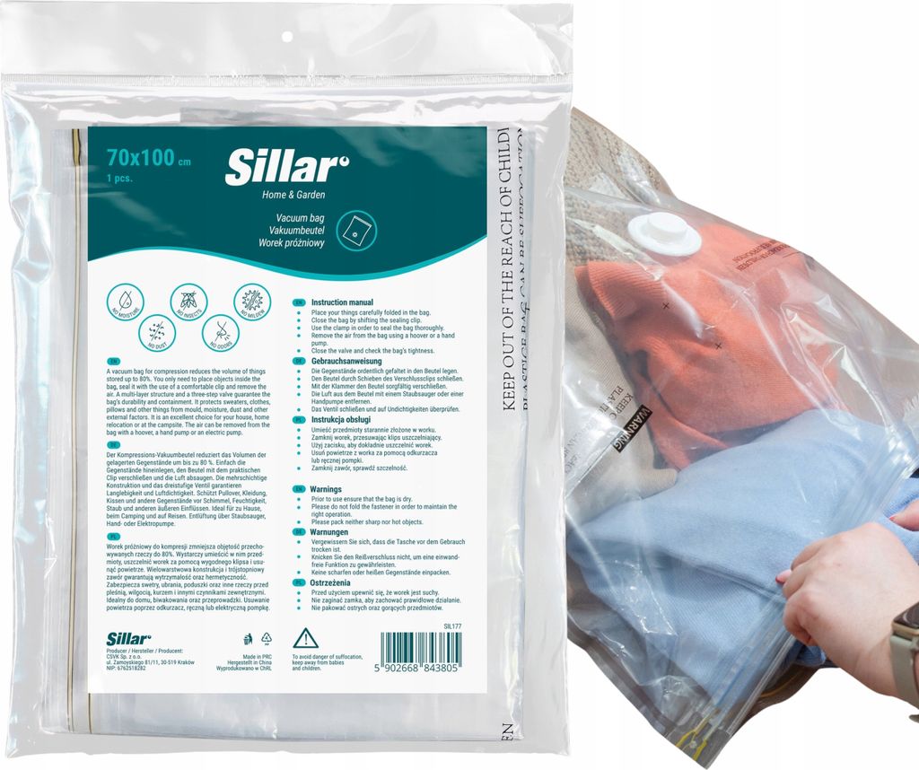 A vacuum bag with clothing inside, and a person's hand pressing on it.
