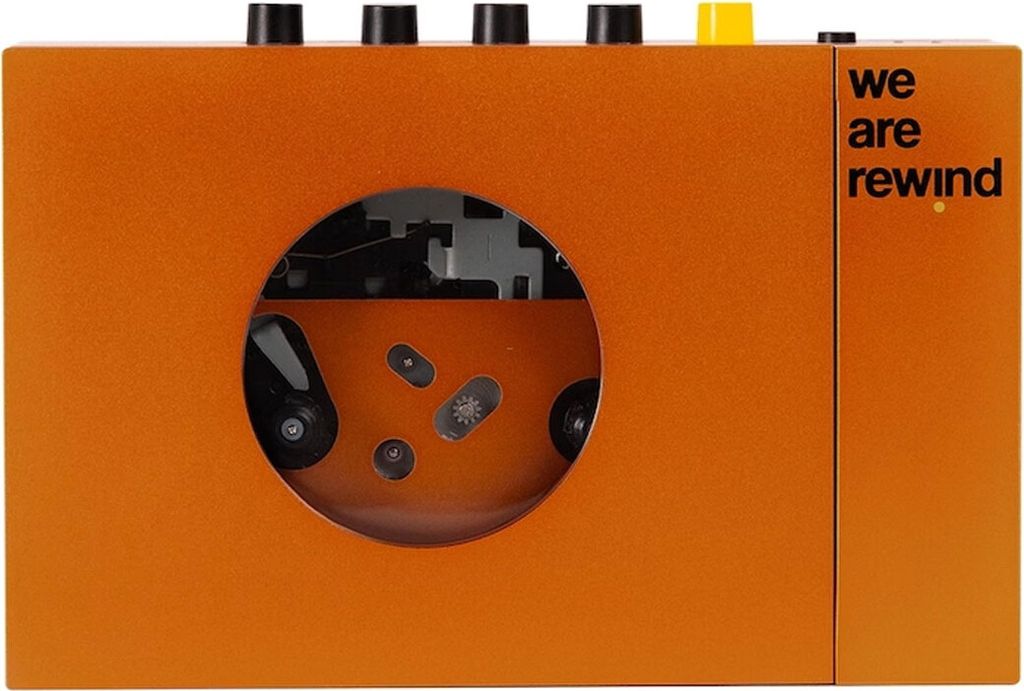 An orange portable cassette player with a circular window showing the cassette mechanism.