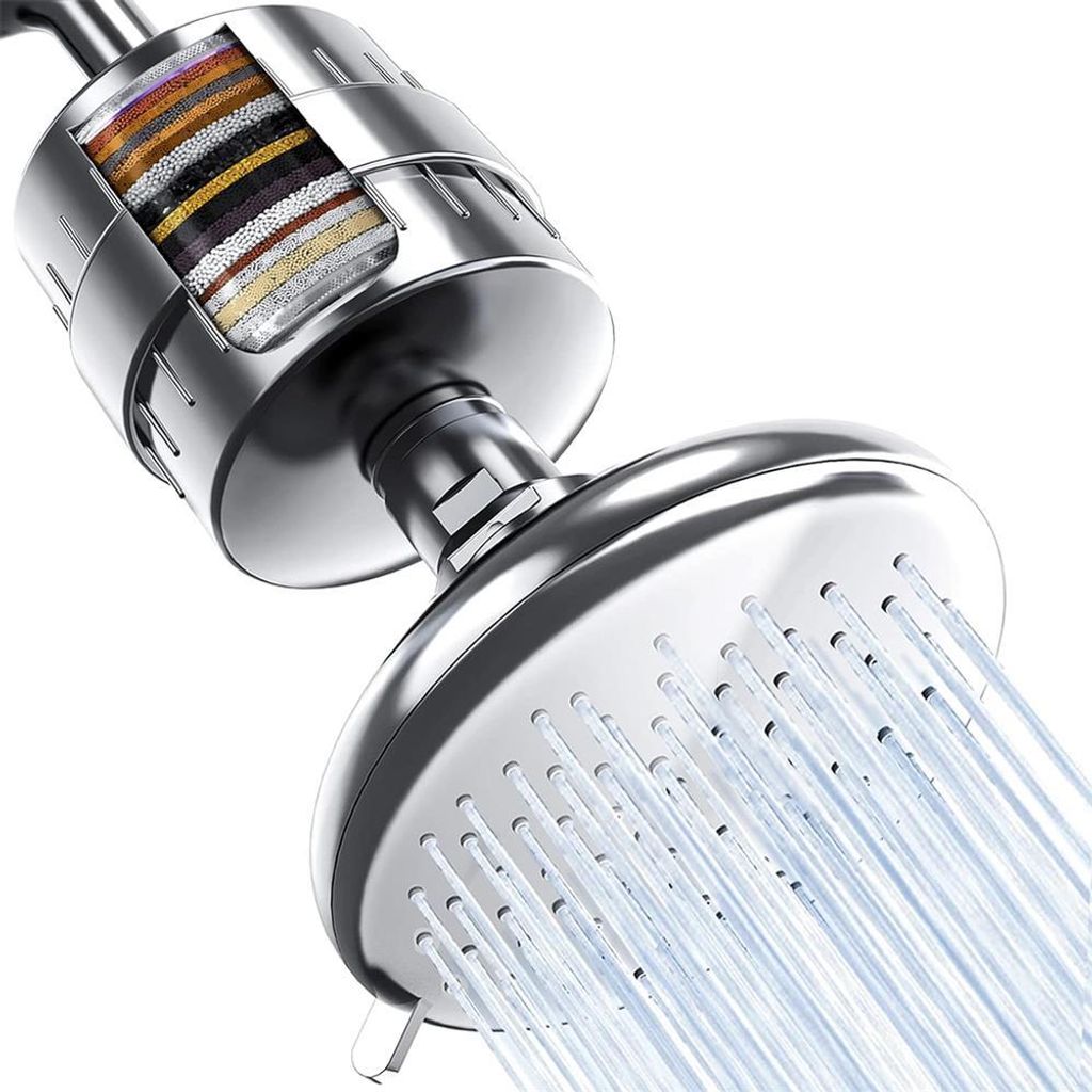 A close-up, cutaway view of a shower head with a visible multi-layer filter inside, showing water spraying from the shower head.