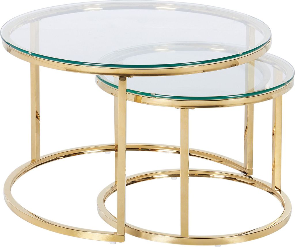A set of two nesting coffee tables with glass tops and gold metal frames.