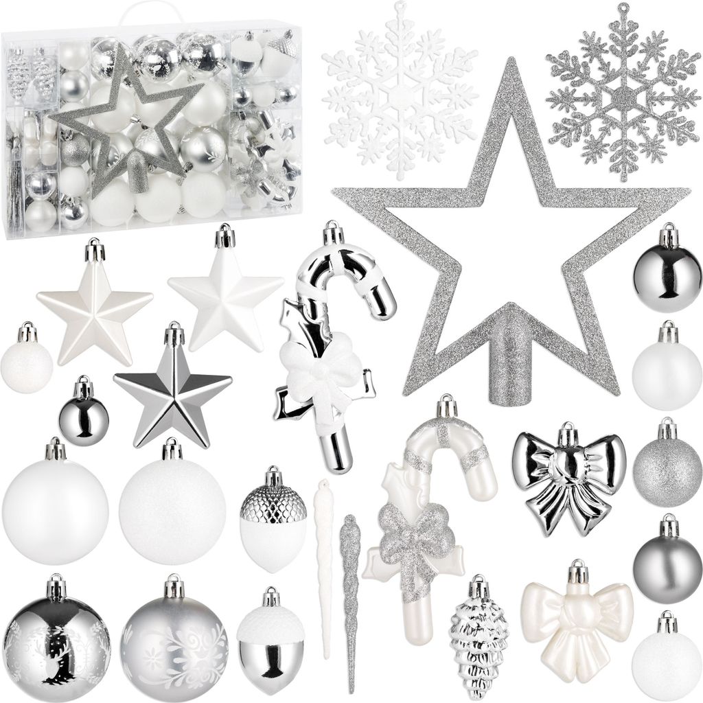 A collection of silver and white Christmas tree ornaments, including baubles, stars, snowflakes, candy canes, icicles, acorns, and pinecones, arranged on a white background.