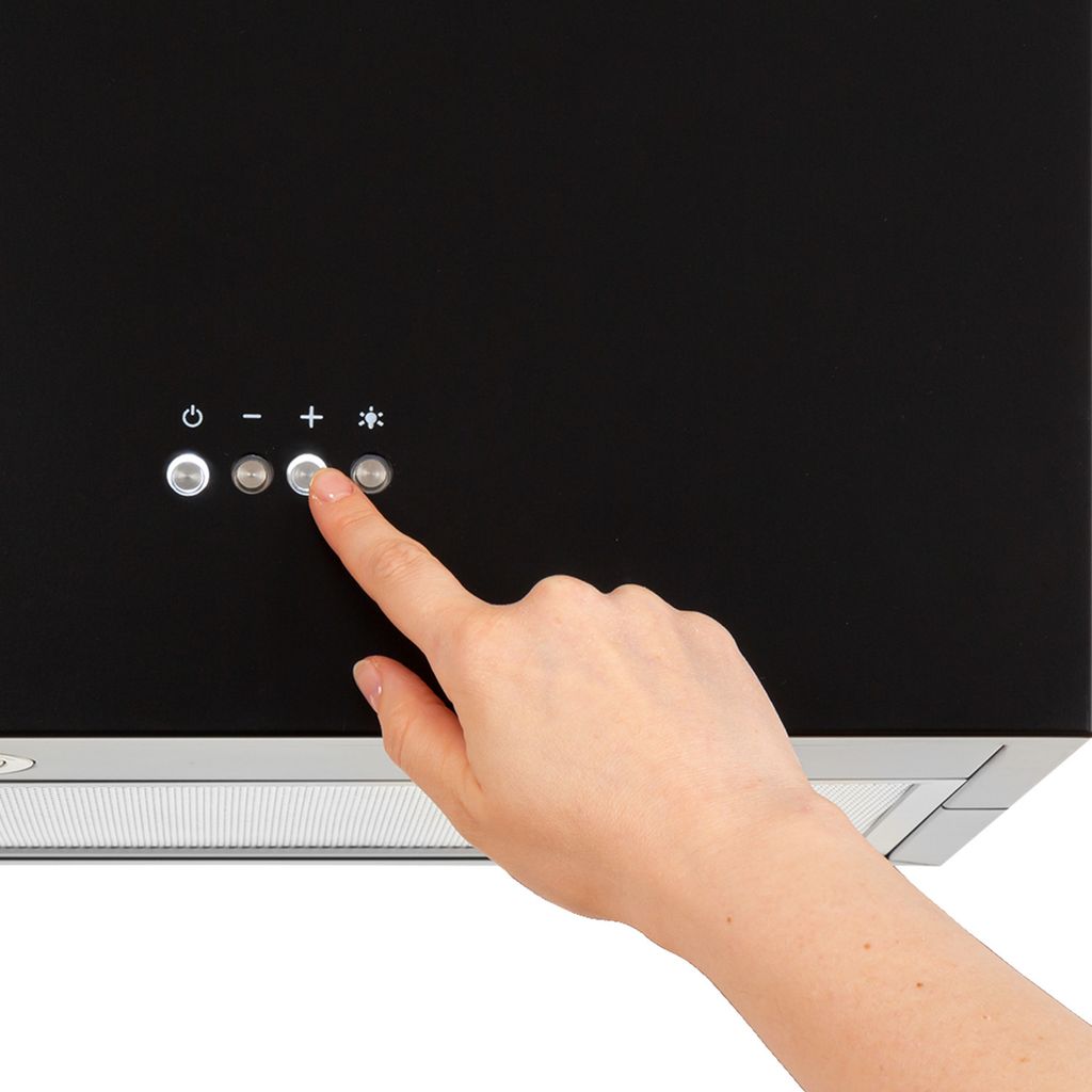 A hand is pressing a button on a black range hood.
