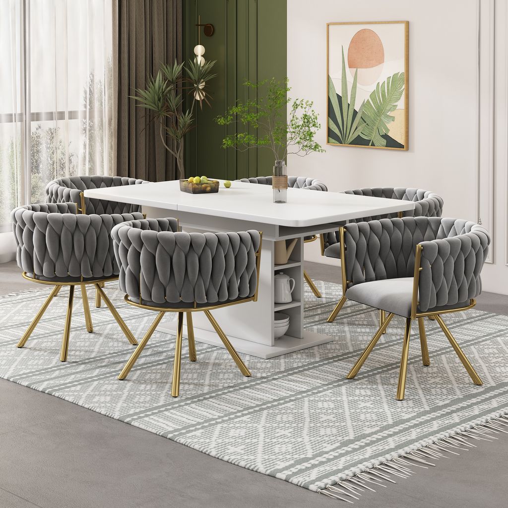A dining room set with a white table and six gray chairs with gold legs, arranged on a patterned rug.