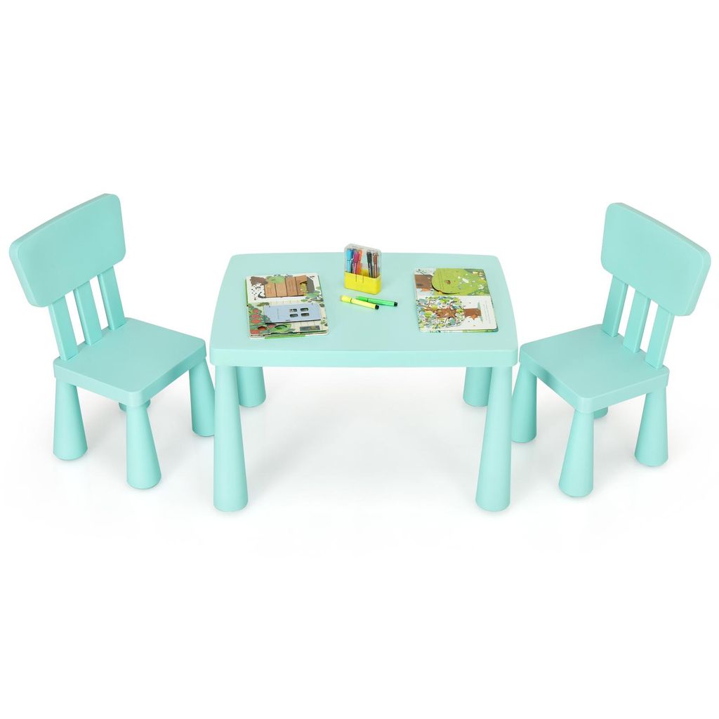 A child's table and two chairs set, with some coloring supplies and books on the table.