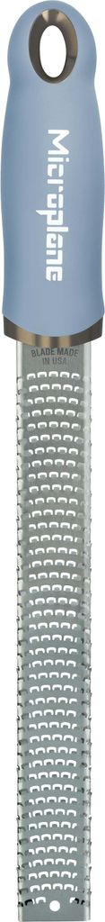 A close-up studio shot of a Microplane grater.
