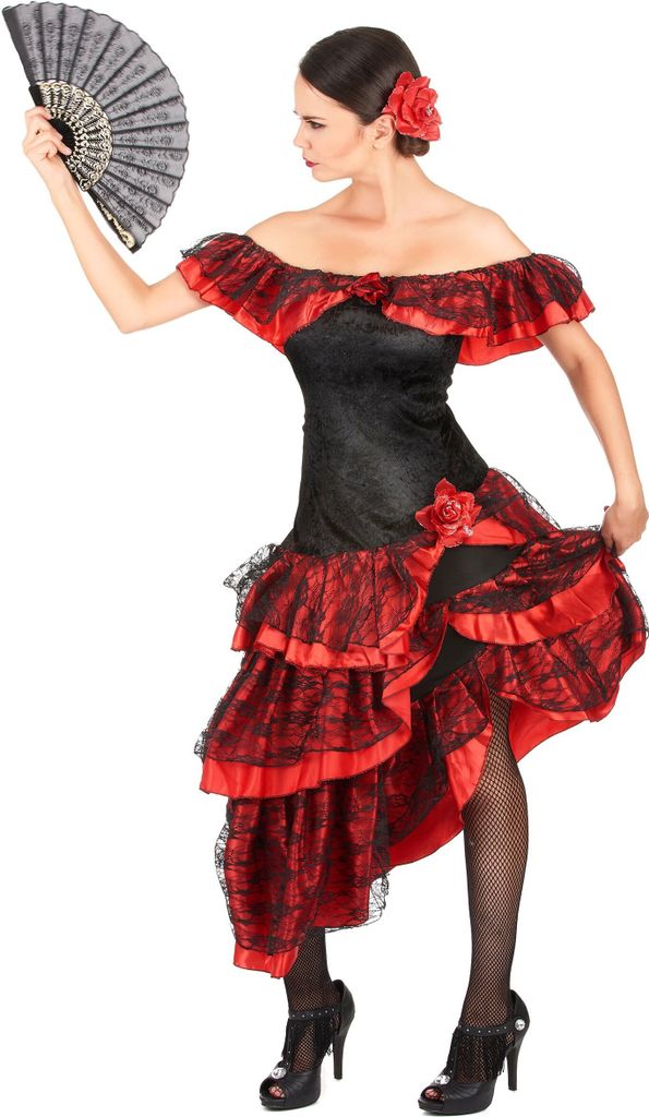 A woman in a flamenco dancer costume holding a fan.